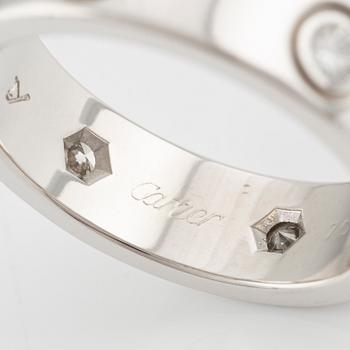 Cartier "Love" ring in 18K white gold with round brilliant-cut diamonds.