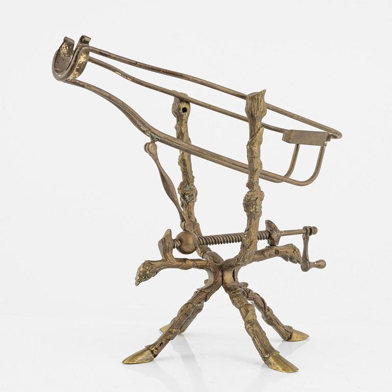 A brass bottle holder, circa 1900.