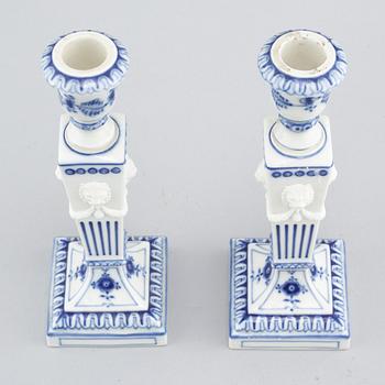 A pair of "Musselmalet" candlesticks in porcelain, by Royal Copenhagen, second half of the 20th century.
