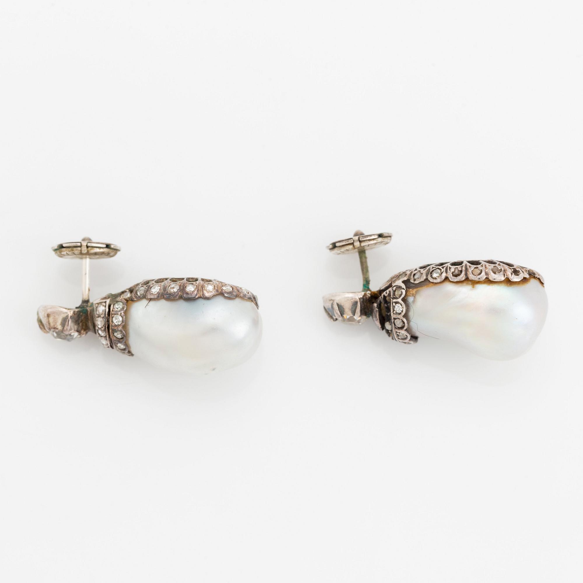 A pair of silver and pearl earrings set with old- and rose-cut diamonds.
