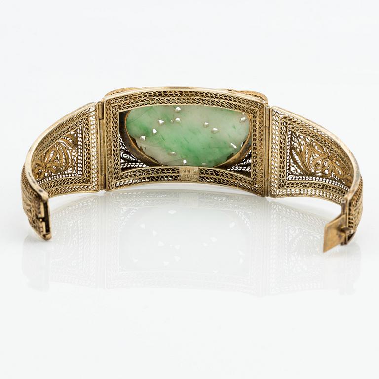 A gilded silver bracelet with stone inlay, late Qing dynasty.