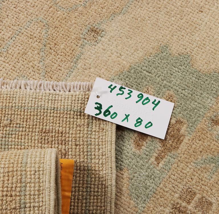 An Ushak runner carpet, c. 360 x 80 cm.