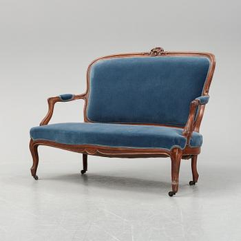 A sofa and a set of four chairs, Rococo revival, late 19th century.