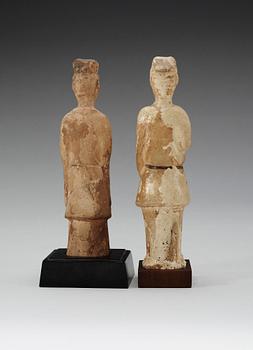 Two glazed pottery figurines of standing officials, with traces of paint, Tang dynasty (618-907).