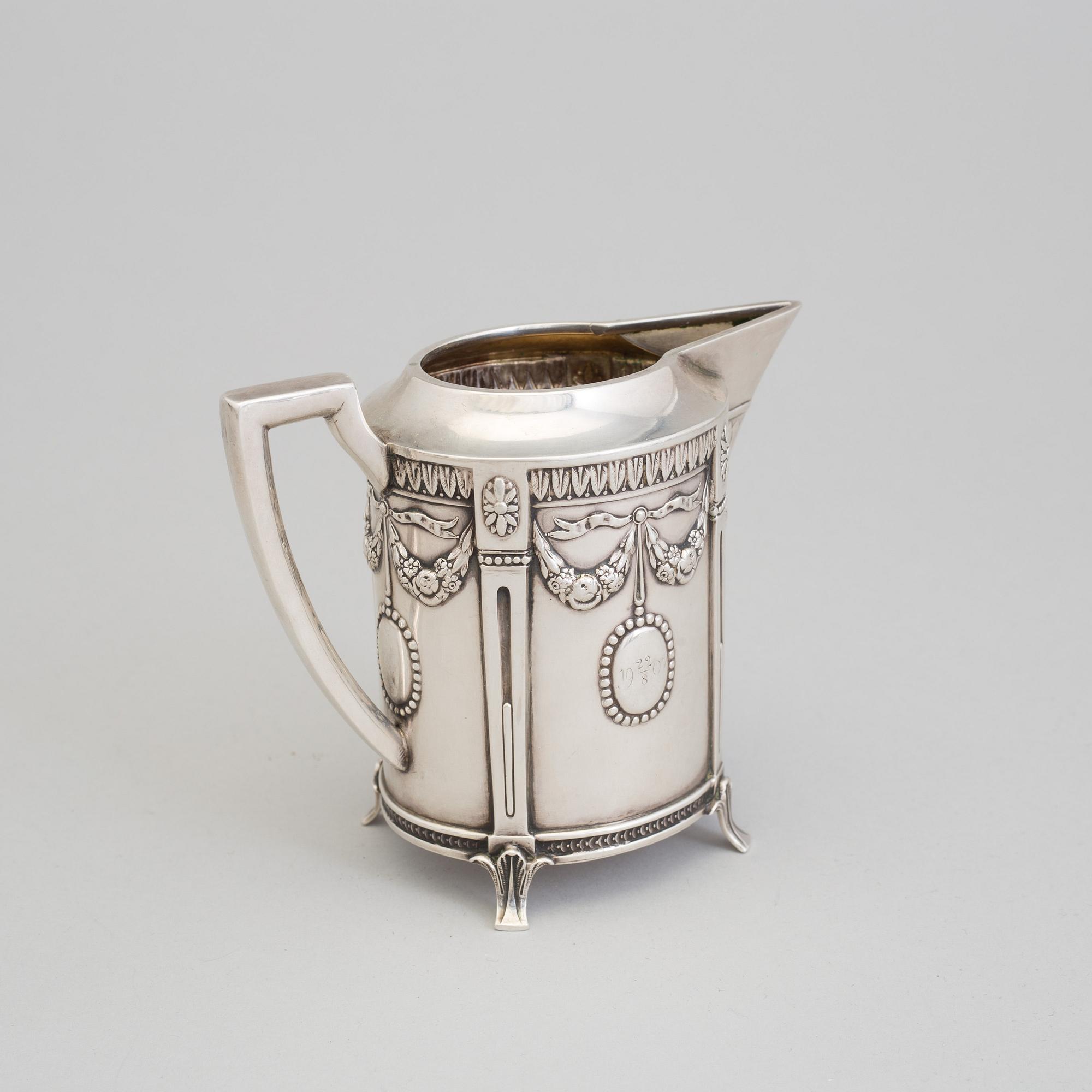 A set of three silver objects (coffeepot, creamer and sugarbowl, CG Hallberg and GAB, Stockholm 1907. Weight ca 1226 gr.