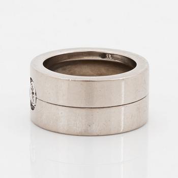 A Cartier 18K white gold ring set with a round brilliant-cut diamond.