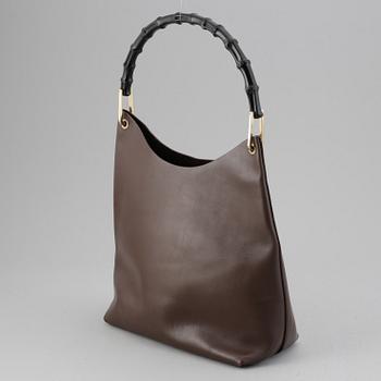 Gucci, a leather bag.