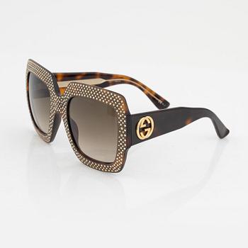 Gucci, a pair of black plastic and rhinestone sunglasses.