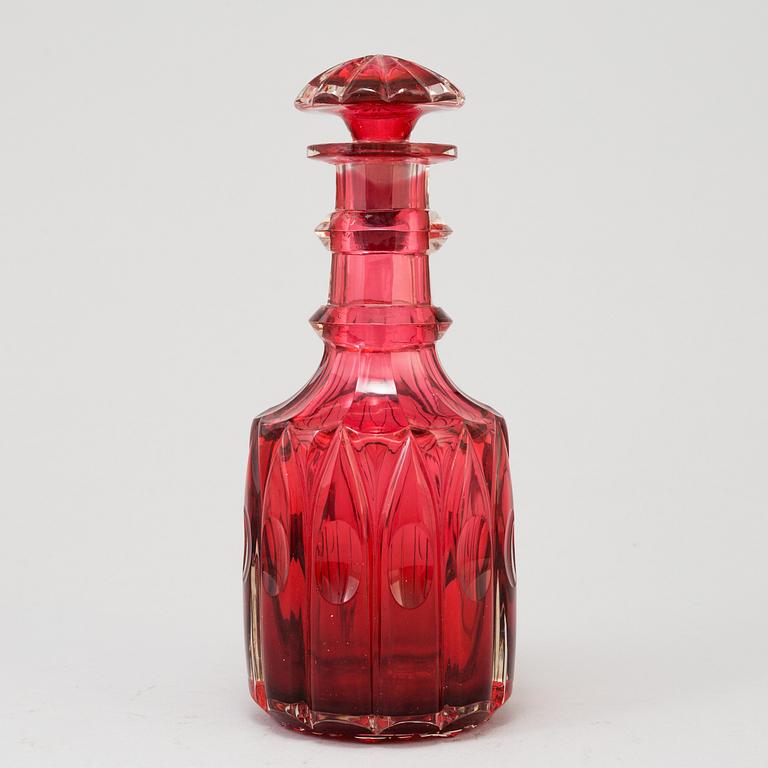 A MID 19TH CENTURY RED GLASS DECANTER AND STOPPER.