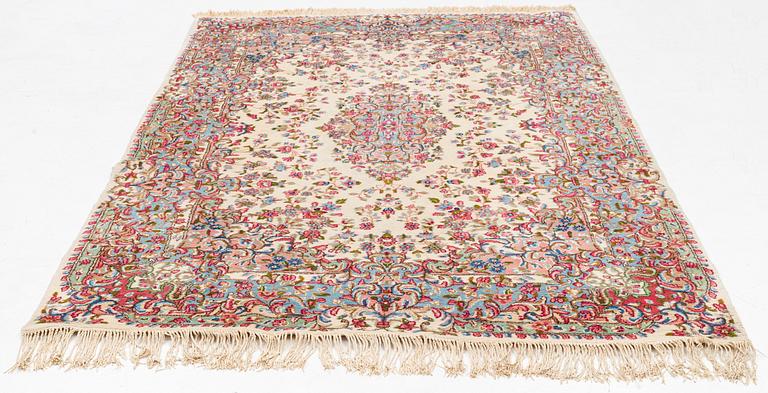 A carpet, semi-antique/old, Kerman, approx. 263 x 174 cm.