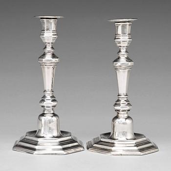 115. A pair of European 18th century silver candlesticks, unidentified makers mark.