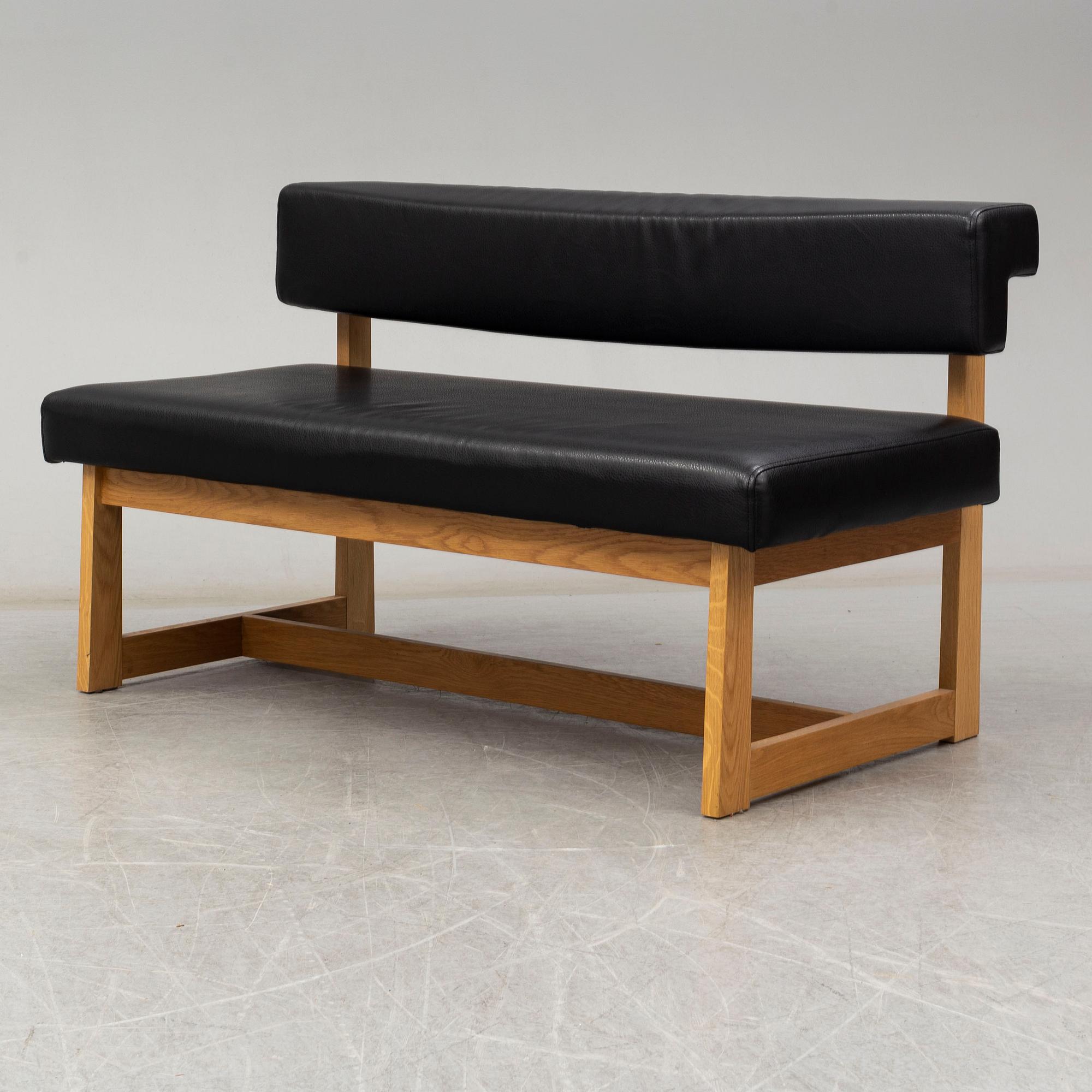 A leather covered oak sofa, 21st Century.
