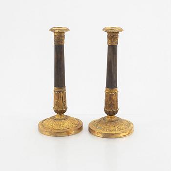 A pair of Empire candle sticks, 19th century.