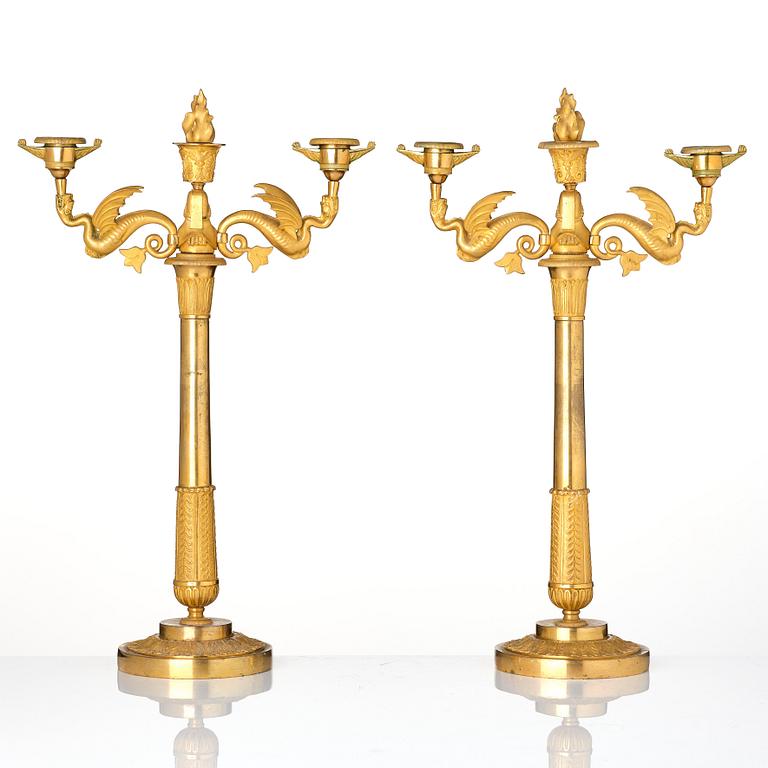 A pair of ormolu three-branch Empire candelabra, early 19th century.