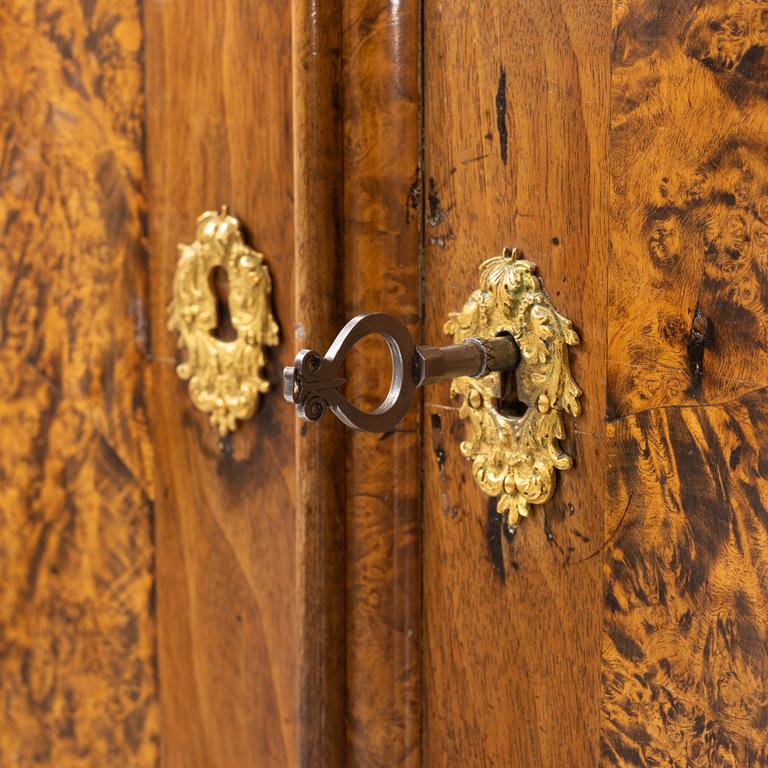 A burr alder, elm, and gilt-brass mounted late Baroque cabinet, first part of the 18th century.