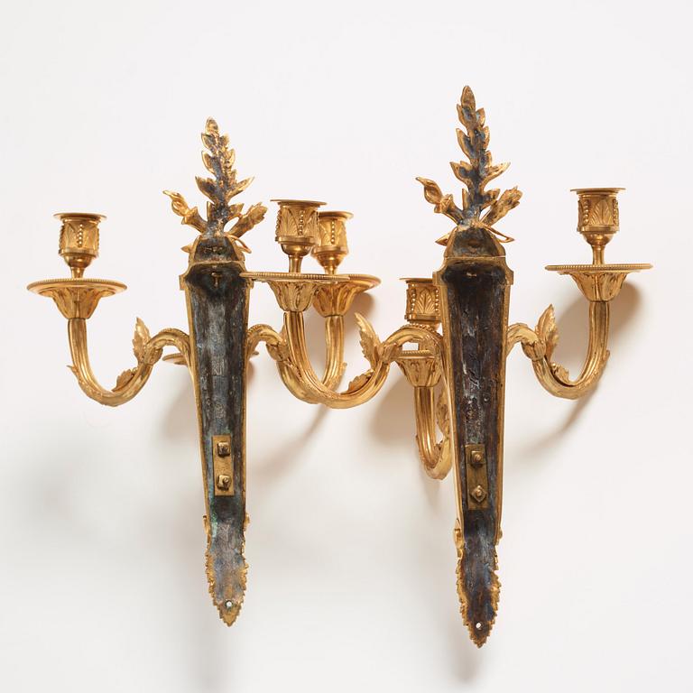 A pair of Louis XVI late 18th century gilt bronze three-light wall-lights.