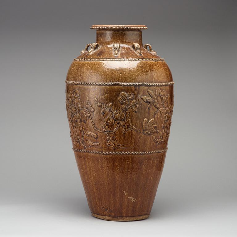 A large brown glazed Martaban jar, presumably 18th Century.