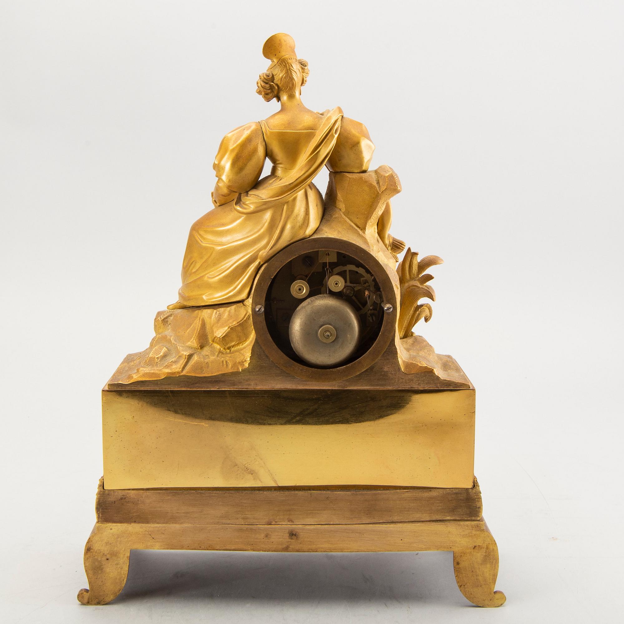 A mid 1800s bronzed late empire table clock.