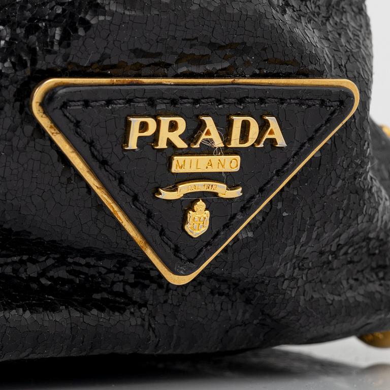 Prada, A black leather and gold stud bag.
