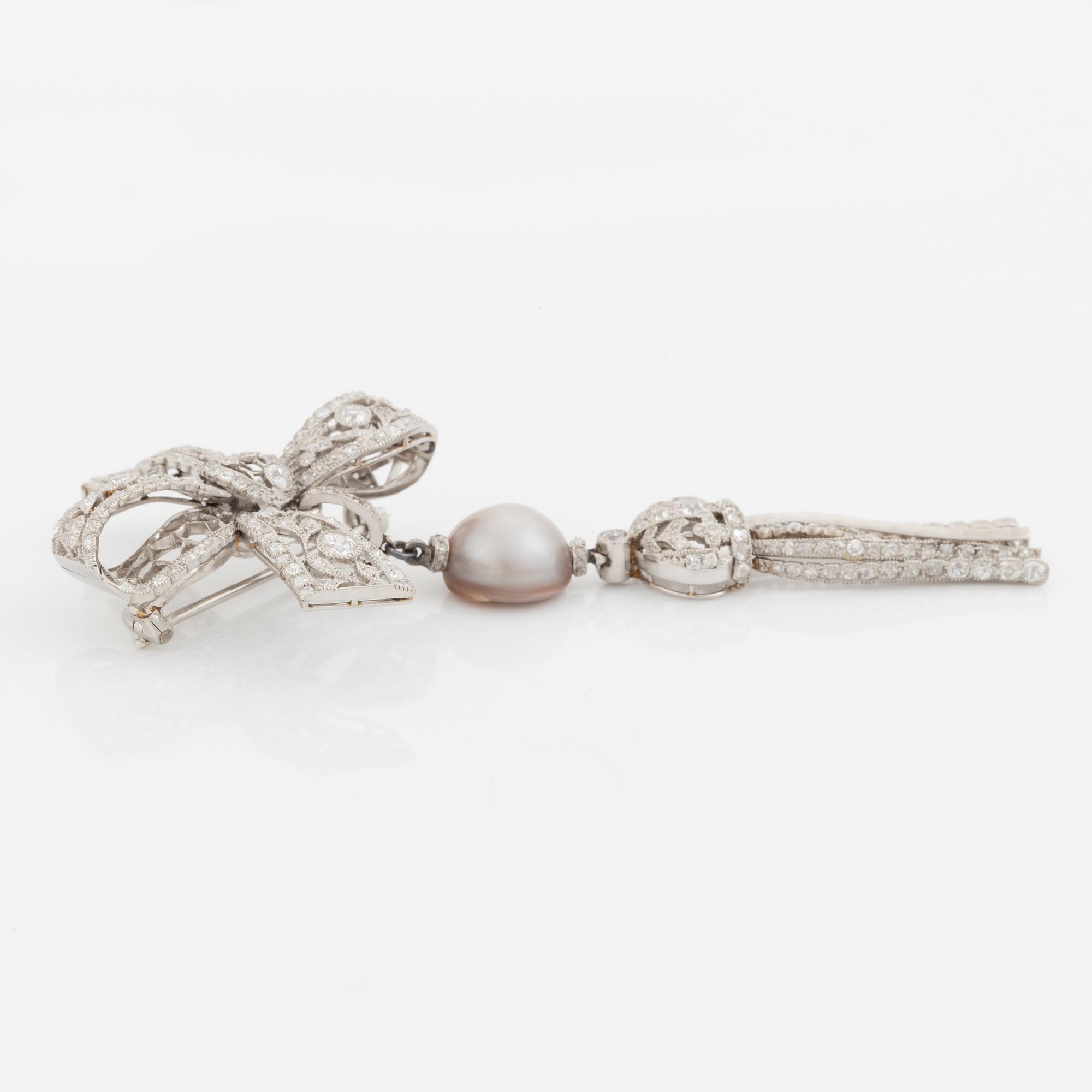 A platinum bow brooch set with old-cut diamonds with a detachable pearl and platinum pendant.