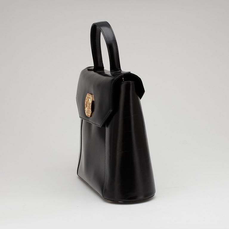YVES SAINT LAURENT, a black leather top handle bag.