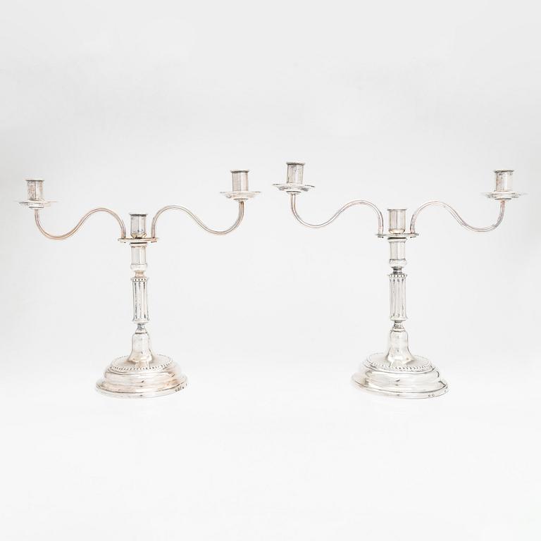 A pair of silver candelabra by Ferdinand Christian Krebs, Breslau, 1776-1792, with snuffers from Reval. Neo-classicism.