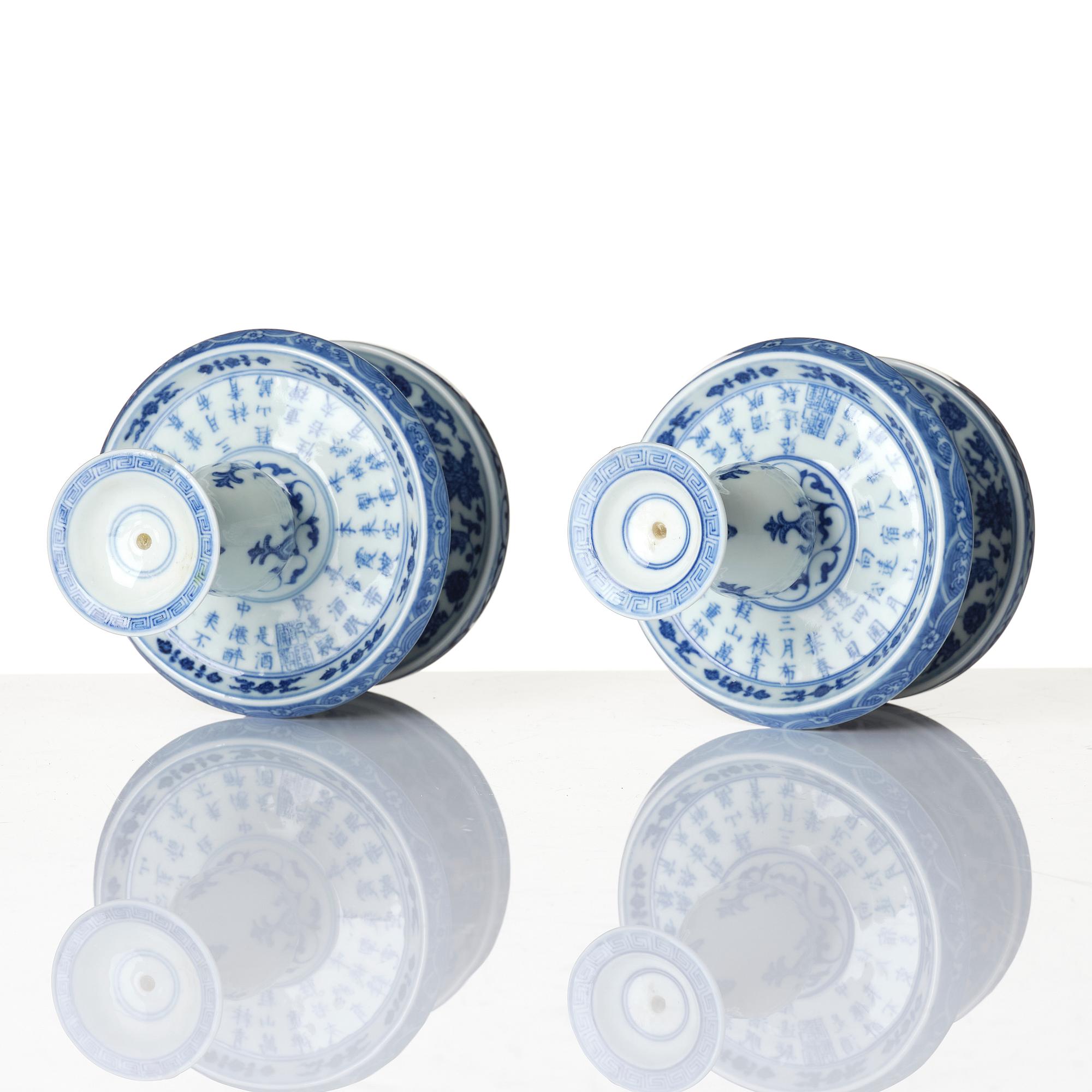 A pair of blue and white pricket candle sticks, with a poem, Qing dynasty with a Qianlong mark and of the period.