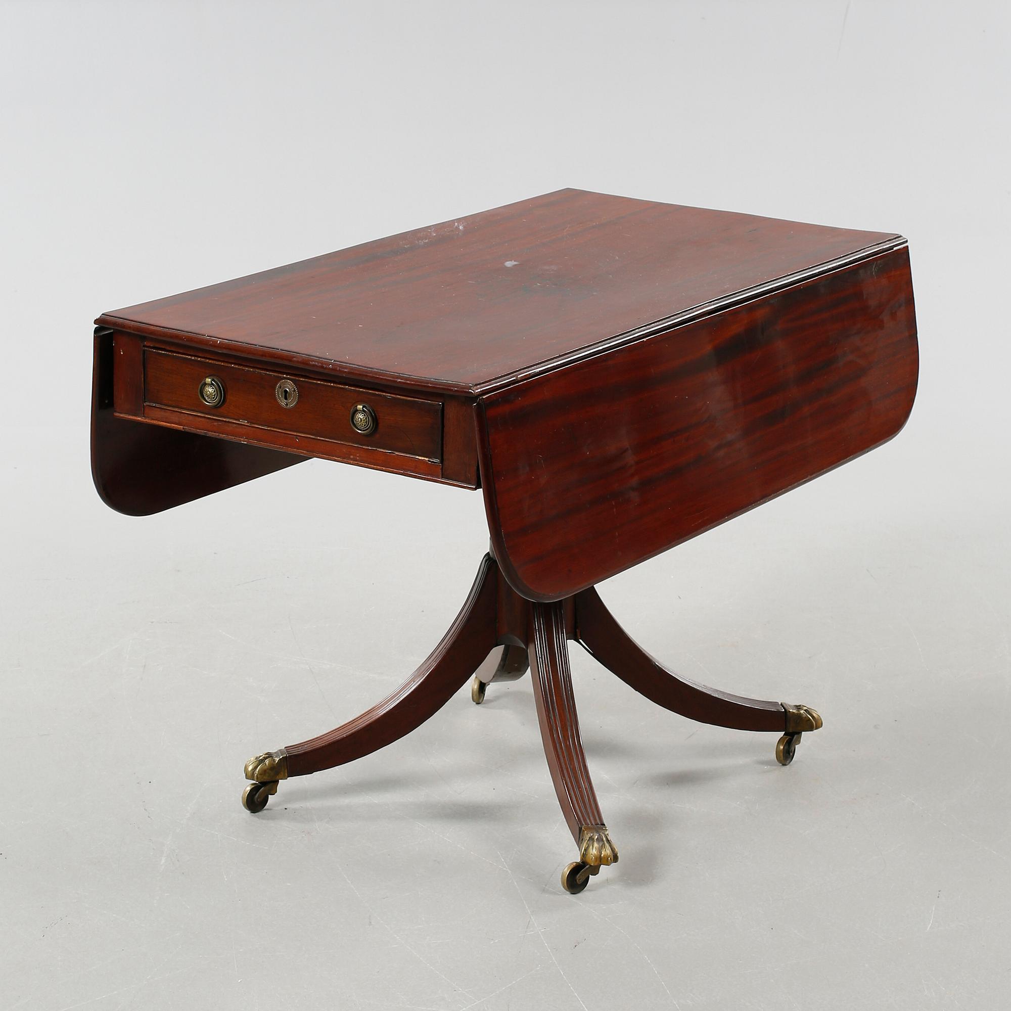 A drop-leaf table, English style, late 19th century.