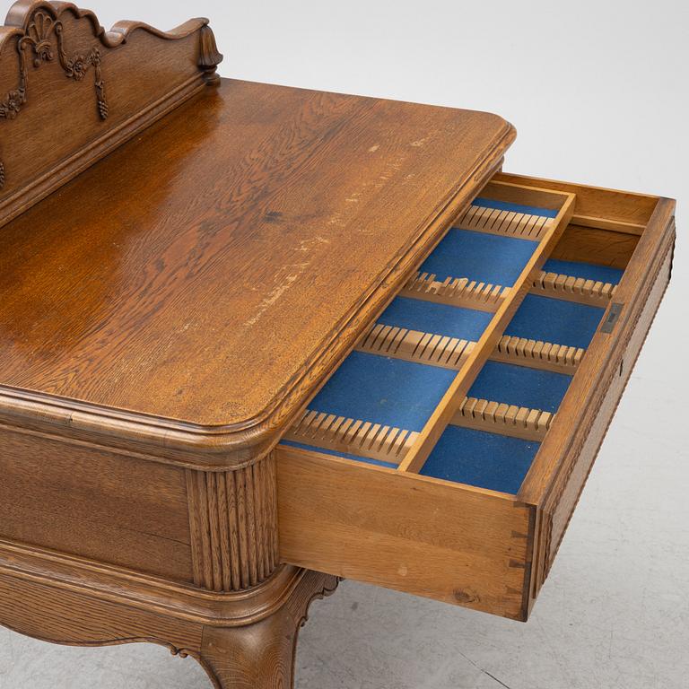 Dining table, 8 chairs, 2 armchairs, sideboard, Rococo style, early 20th century.
