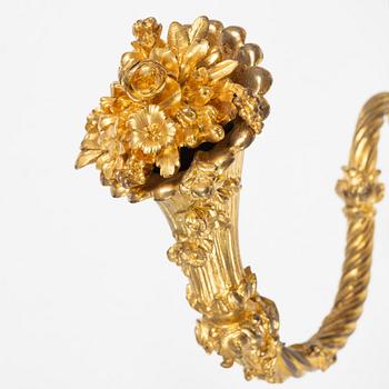 A set of four gilt bronze Louis XVI-style curtain holders, late 19th century.