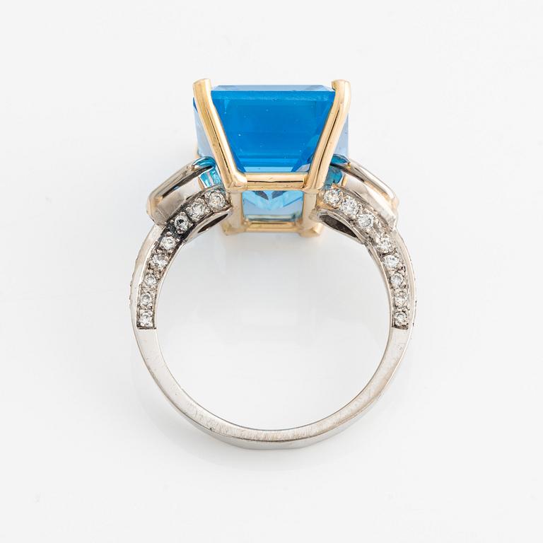 Ring, cocktail ring with large blue topaz and brilliant-cut diamonds.