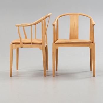 A pair of Hans J Wegner 'China chairs', Fritz Hansen, Denmark 1986-87.