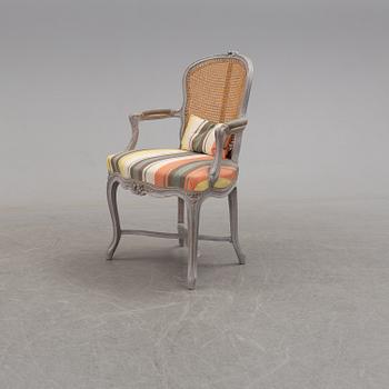 A later part of the 19th century rococo style armchair and second half of the 20th century stool.