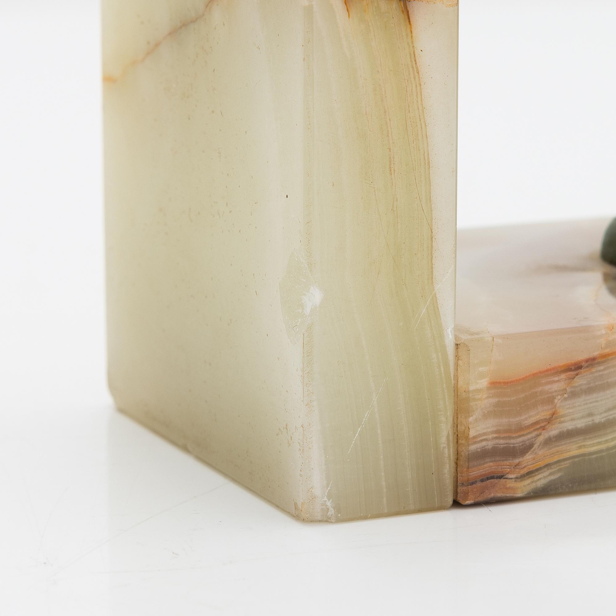 A pair of alabaster and  patinated metal Art Deco bookends from the first half of the 20th Century.