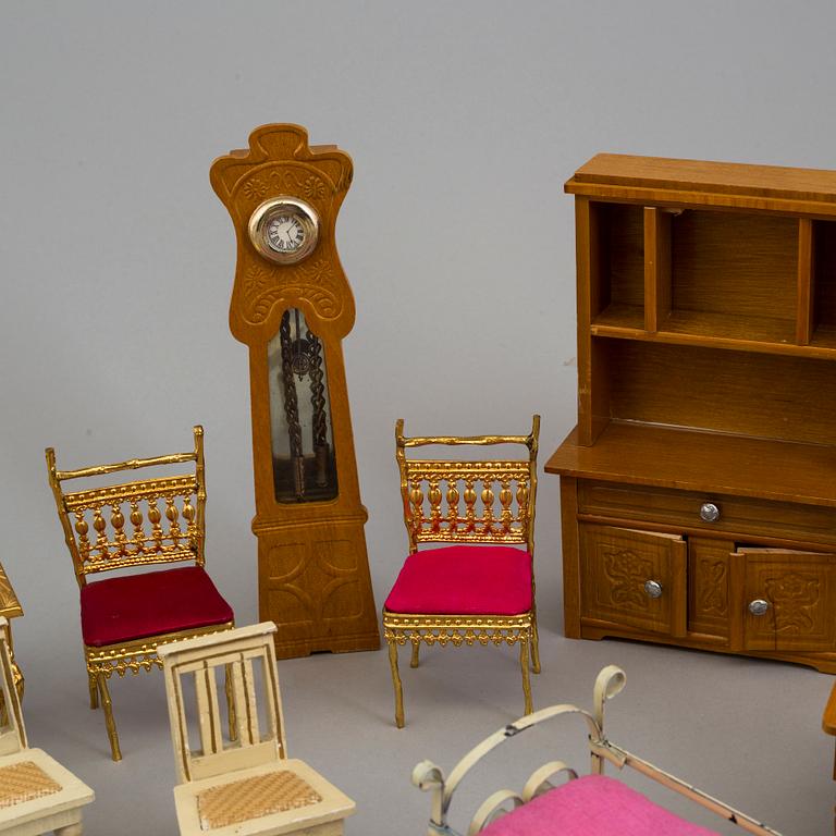 A doll house with interior and dolls ca 1910.