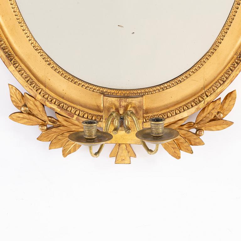 A late Gustavian two-light girandole mirror, circa 1800.