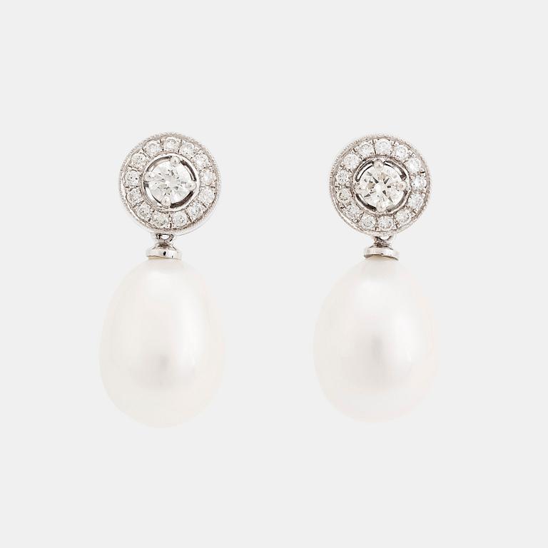 A pair of 18K white gold and cultured pearls earrings set with round brilliant-cut diamonds.