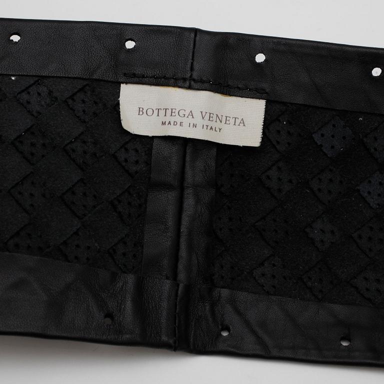 BOTTEGA VENETA, a black leather cover for the steering wheel.