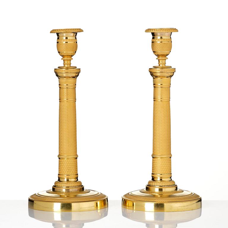 A pair of French Empire gilt-bronze candlesticks, early 19th century.