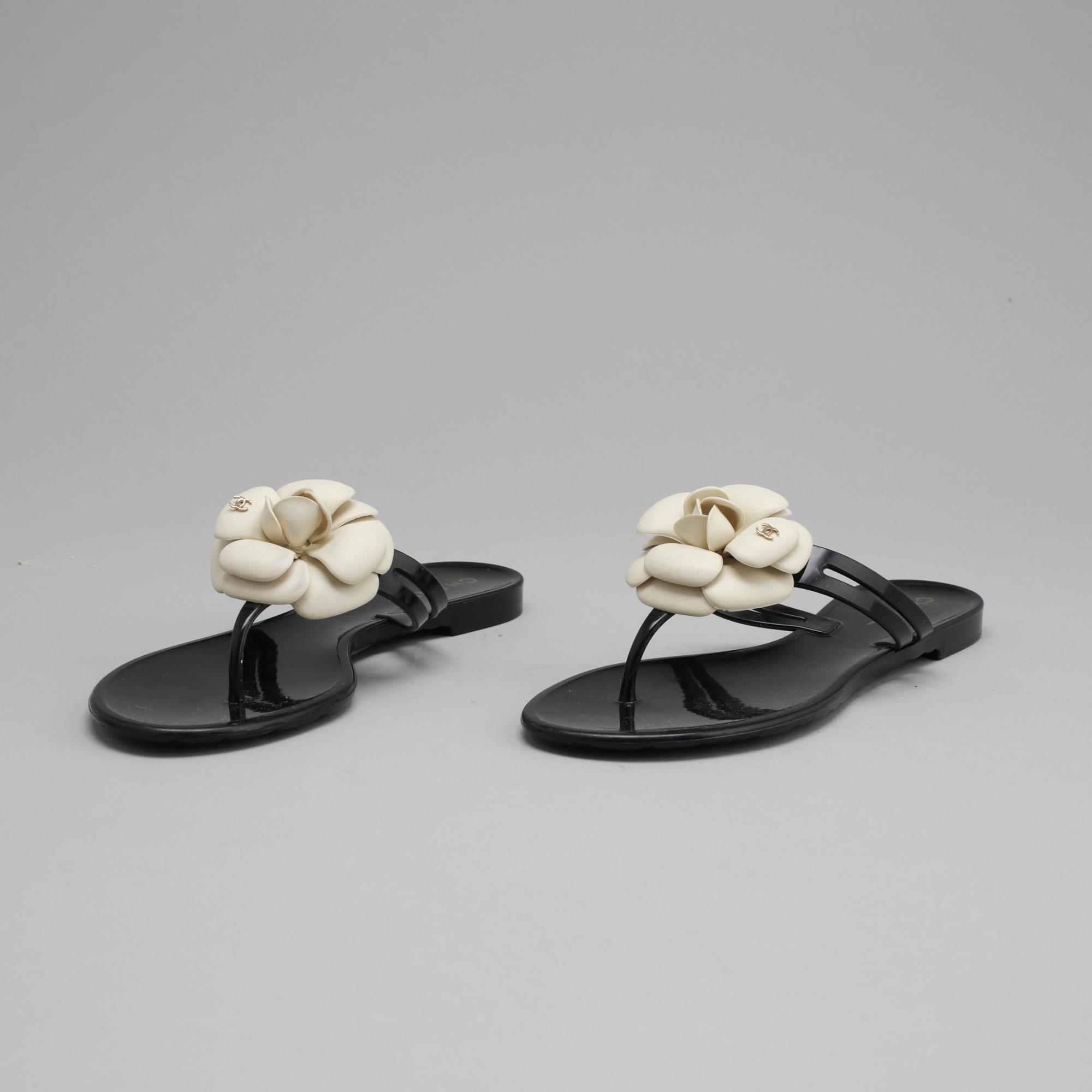 CHANEL a pair of black plastic sandals. Size 38. Bukowskis
