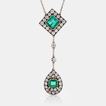 1135. A necklace set with two faceted emeralds and old-cut diamonds.