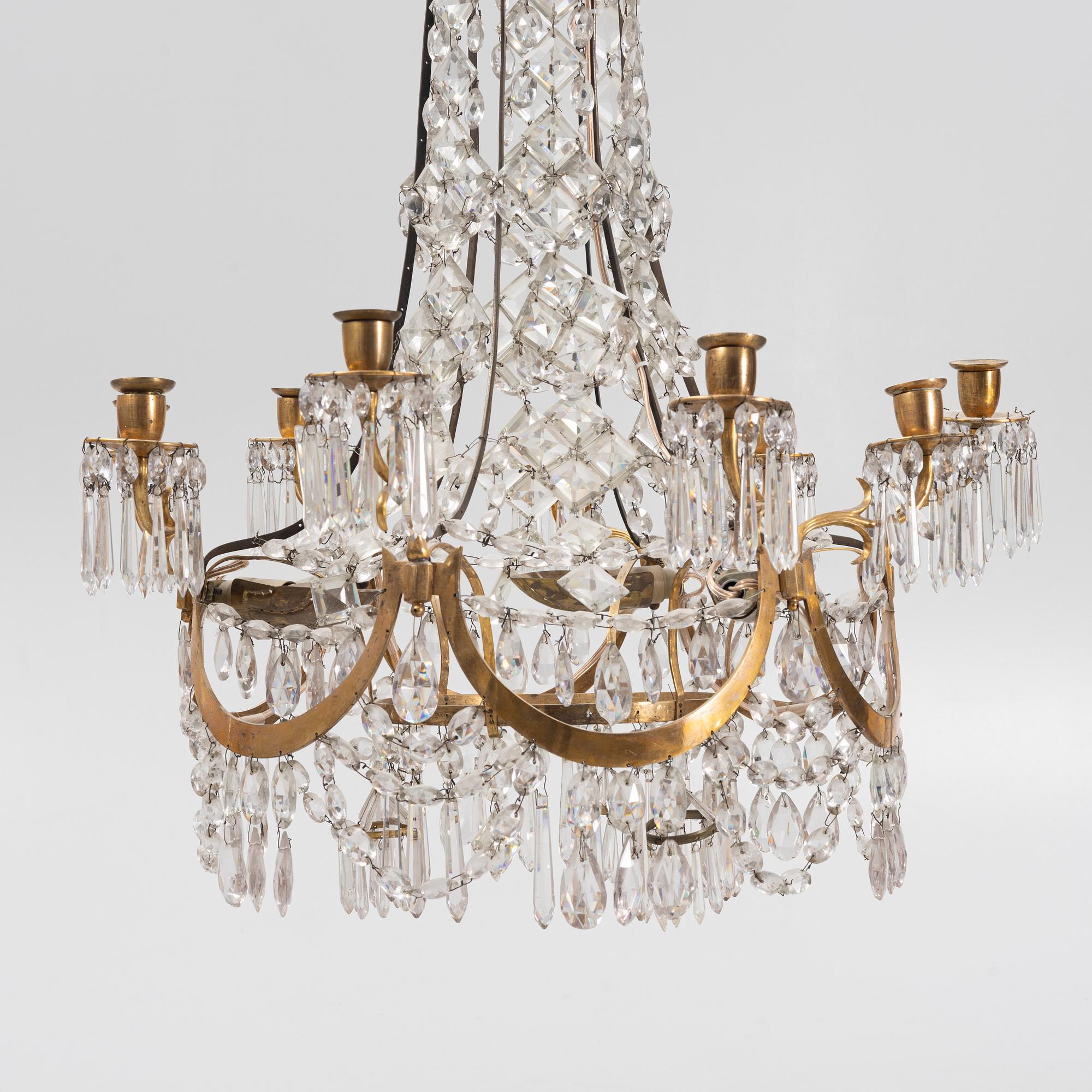 A Louis XVI gilt-brass and cut glass nine-light chandelier, circa 1800.