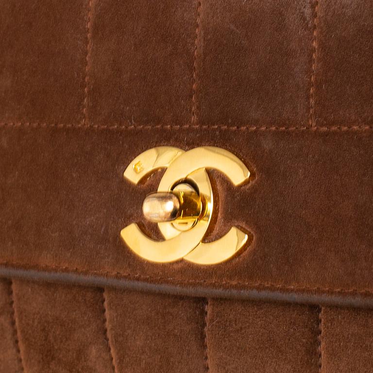 CHANEL, a suede hand bag.
