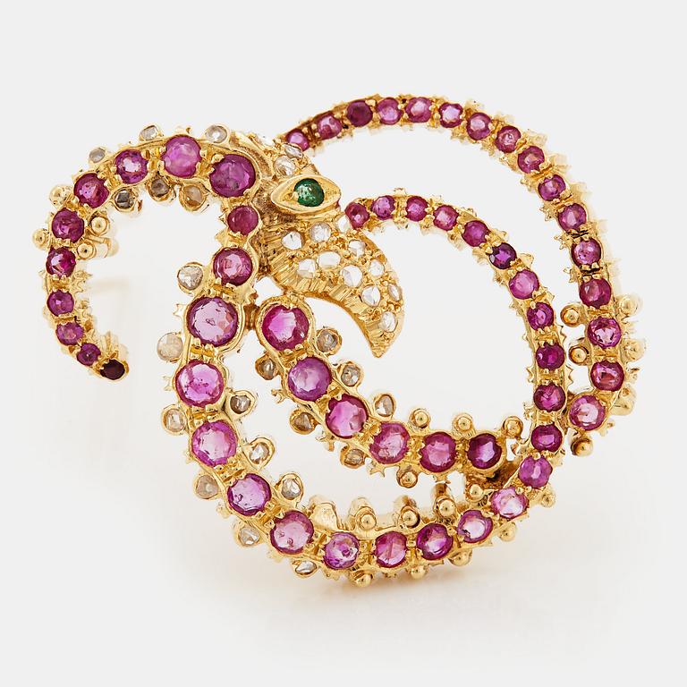 An Ilias Lalaounis brooch in 18K gold set with faceted rubies, an emerald and rose-cut diamonds.