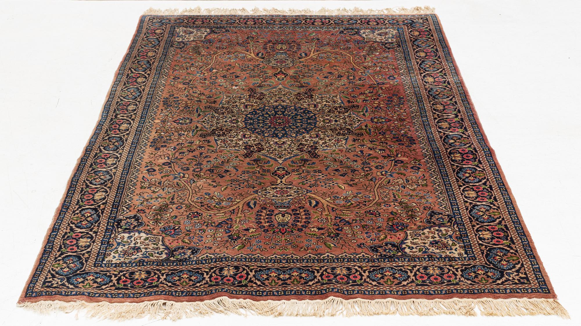 An oriental rug, circa 245 x 136 cm.
