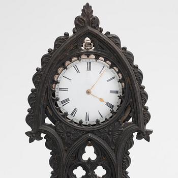 A neo-gothic cast iron pocket watch stand with a pocket watch. 19th century.