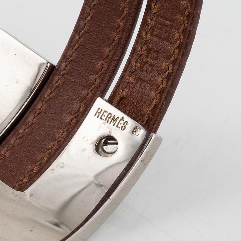 Hermès, a brown leather and palladium metal 'Pousse Pousse' bracelet.