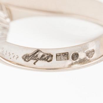 An 18K white gold Engelbert ring set with a aquamarine and round brilliant-cut diamonds.
