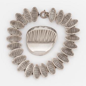 A 1950's silver bracelet and brooch.