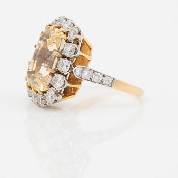 A 12.41 ct untreated yellow sapphire and brilliant cut diamond ring. Total carat weight of diamonds circa 1.95 ct.